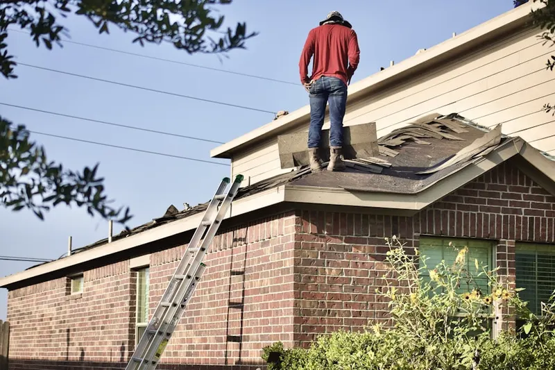 Professional roofer working on a residential roof in Leithtown